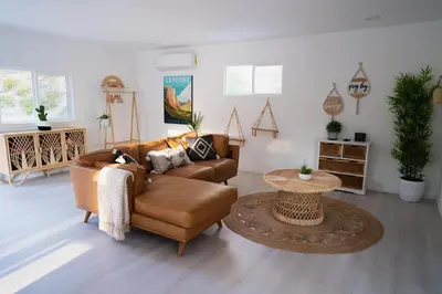 a living room with a couch and a table at Boho chic oasis by Casa Oso with pool, spa and views in Ahwahnee