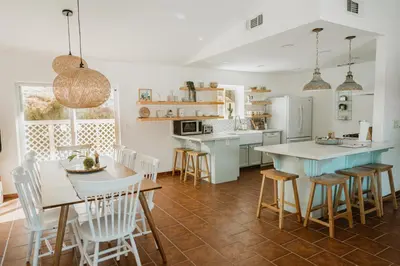 a kitchen and dining room with a table and chairs at Boho chic oasis by Casa Oso with pool, spa and views in Ahwahnee