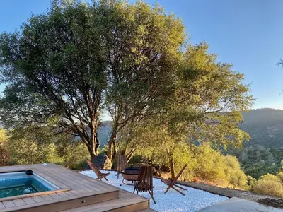 a house with a pool and a table and chairs at Boho chic oasis by Casa Oso with pool, spa and views in Ahwahnee