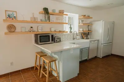 a kitchen with a counter with a microwave and a refrigerator at Boho chic oasis by Casa Oso with pool, spa and views in Ahwahnee