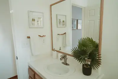 a bathroom with a sink and a large mirror at Boho chic oasis by Casa Oso with pool, spa and views in Ahwahnee