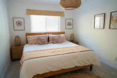 a bedroom with a bed with pillows and a window at Boho chic oasis by Casa Oso with pool, spa and views in Ahwahnee