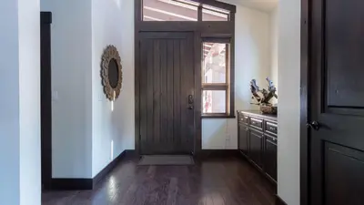 a hallway with a wooden door and a window at Modern Mountain Home w Cozy Fire Pit 15 Mins frm Northstar Maple by AvantStay in Ponderosa Fairway Estates