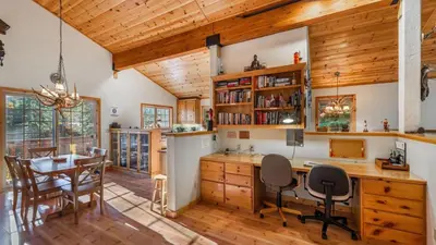 a kitchen and dining room with a table and chairs at Wolfs Lair by AvantStay Swiss Chalet w Private Hot Tub Access to Northstar Resort Community in Kingswood Estates