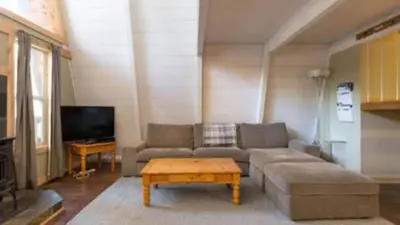 a living room with a couch and a coffee table at Zephyr by AvantStay Stylish Modified A Frame w Access To Tahoe Donner in Truckee
