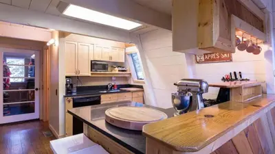a kitchen with a counter with a mixer on it at Zephyr by AvantStay Stylish Modified A Frame w Access To Tahoe Donner in Truckee