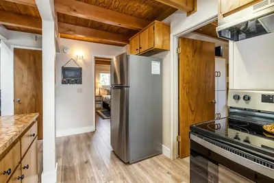a kitchen with a stainless steel refrigerator and wooden cabinets at 3 Wild Turkeys Family Friendly Home in Groveland