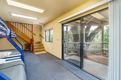 a room with a bunk bed and a balcony at 3 Wild Turkeys Family Friendly Home in Groveland
