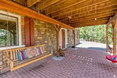 a porch of a stone building with a bench at The Happy Place Mountain View Home in Groveland