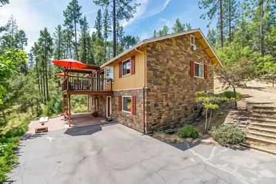 a house in the woods with a balcony at The Happy Place Mountain View Home in Groveland