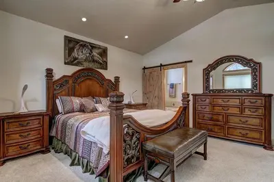 a bedroom with a bed and a dresser and a mirror at Lukins Lodge By The Lake Hot Tub in South Lake Tahoe