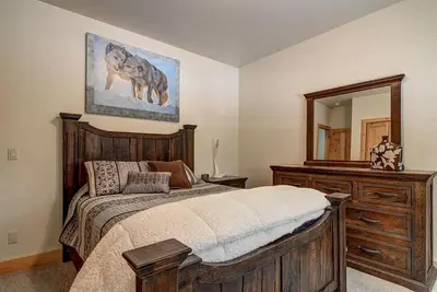 a bedroom with a bed with a dresser and a mirror at Lukins Lodge By The Lake Hot Tub in South Lake Tahoe