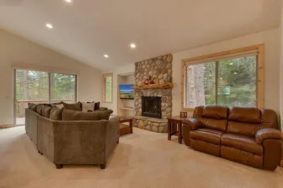 a living room with two couches and a fireplace at Lukins Lodge By The Lake Hot Tub in South Lake Tahoe