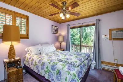 a bedroom with a bed and a ceiling fan at Pet Friendly The Hideout Yosemite Home in Groveland