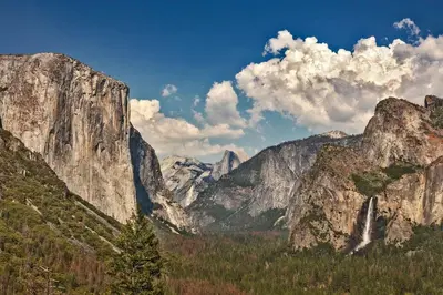 a view of a mountain range with a tree in the foreground at Pet Friendly The Hideout Yosemite Home in Groveland