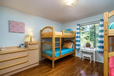 a childs bedroom with bunk beds and a desk at Casa Del Lago - Only 200 Yards from the Beach in Groveland