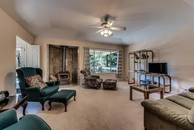 a living room with a couch and chairs and a fireplace at Casa Del Lago - Only 200 Yards from the Beach in Groveland