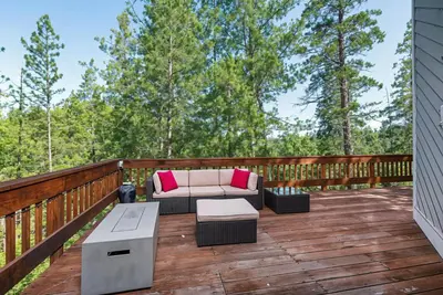 a patio with a couch and a table on a deck at Miner's Claim - Home with 2 Decks & Pool in Groveland