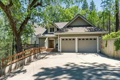 a house with a driveway and a fence at Miner's Claim - Home with 2 Decks & Pool in Groveland