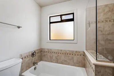 a bathroom with a bath tub and a window at The Big Easy Lakefront Cabin in Groveland