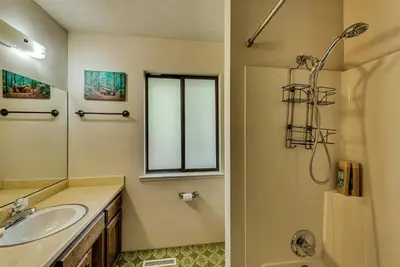a bathroom with a sink and a shower at Pet Friendly Grizzly Blair Lodge Cabin in Groveland