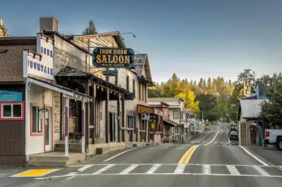 an empty street in a town with a sign for a shop at Lakefront Cozy Cabin on the Cove in Groveland