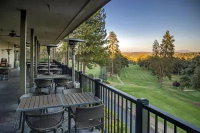 a row of tables and chairs on a balcony with a view at Lakefront Cozy Cabin on the Cove in Groveland