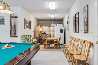 a room with a pool table and chairs at Star of the Mountain Yosemite Home in Groveland