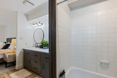 a bathroom with a tub and a sink and a mirror at Luxurious 2 Bedroom Base Camp Condo - Steps from Kirkwood Village condo in Kirkwood
