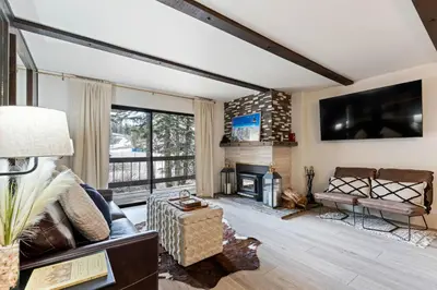 a living room with a couch and a fireplace at Luxurious 2 Bedroom Base Camp Condo - Steps from Kirkwood Village condo in Kirkwood
