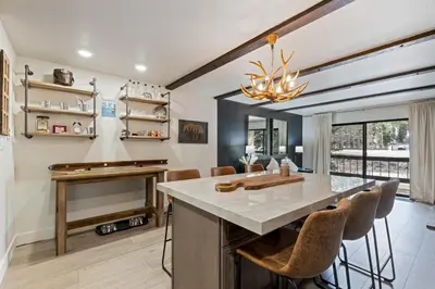 a kitchen with a large island and a piano at Luxurious 2 Bedroom Base Camp Condo - Steps from Kirkwood Village condo in Kirkwood
