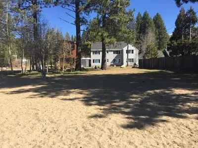a large yard in front of a white house at Lakeside Hotel room #2 in Kings Beach in Kings Beach