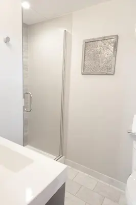 a white bathroom with a shower and a toilet at Lakeside Hotel room #2 in Kings Beach in Kings Beach
