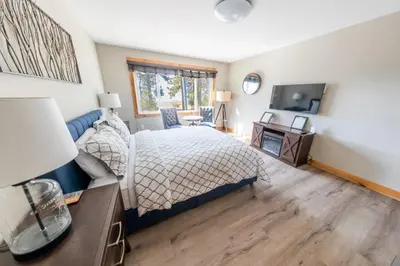 a bedroom with a bed and a desk and a television at Lakeside Hotel room #6 in Kings Beach in Kings Beach