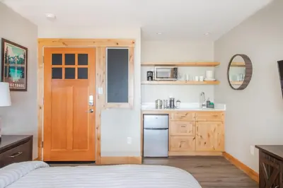a kitchen with a bed and a wooden door at Lakeside Hotel room #6 in Kings Beach in Kings Beach