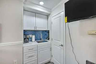 a kitchen with white cabinets and a sink at Cute Central Placerville Studio Pet Friendly in Placerville