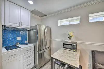 a kitchen with a refrigerator and a table with a microwave at Cute Central Placerville Studio Pet Friendly in Placerville