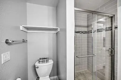a bathroom with a toilet and a glass shower at Cute Central Placerville Studio Pet Friendly in Placerville