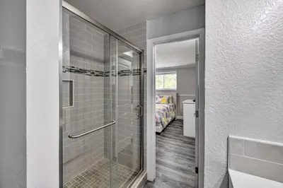 a bathroom with a shower with a glass door at Cute Central Placerville Studio Pet Friendly in Placerville