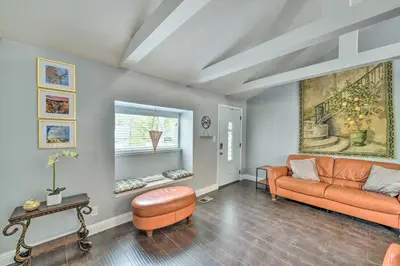 a living room with an orange couch and a window at Less Than 3 Mi to Dtwn Placerville Home with Outdoor Oasis in Placerville
