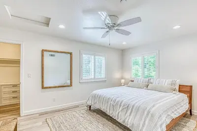 a bedroom with a bed and a ceiling fan at Slide Creek Retreat in Bass Lake