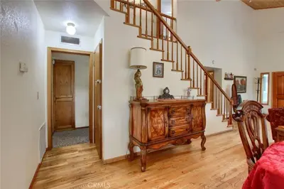 a living room with a staircase and a wooden dresser at Beautiful Pet-Friendly Spacious Lodge near Yosemite & Lakes 12 Beds 6 BR up to 16 people in Oakhurst