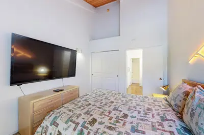 a bedroom with a large flat screen tv on the wall at Chamonix 20 in Mammoth Lakes