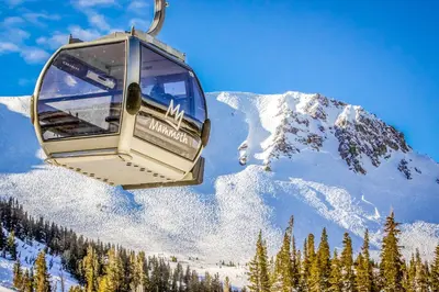 a ski lift going up a snow covered mountain at Chamonix 20 in Mammoth Lakes