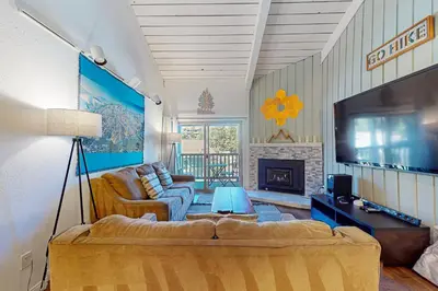 a living room with a couch and a tv at Chamonix 20 in Mammoth Lakes