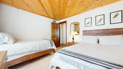 a bedroom with two beds and a wooden ceiling at Chateau Sans Nom #19 condo in Mammoth Lakes