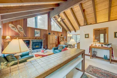 a living room with a couch and a fireplace at Grizzly Cabin in Truckee