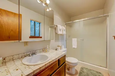 a bathroom with a sink and a shower and a toilet at Grizzly Cabin in Truckee