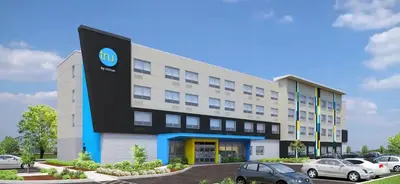 a building with cars parked in a parking lot at Tru By Hilton Manteca in Manteca