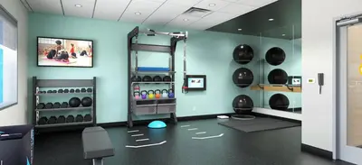 a room with a gym with a lot of helmets at Tru By Hilton Manteca in Manteca